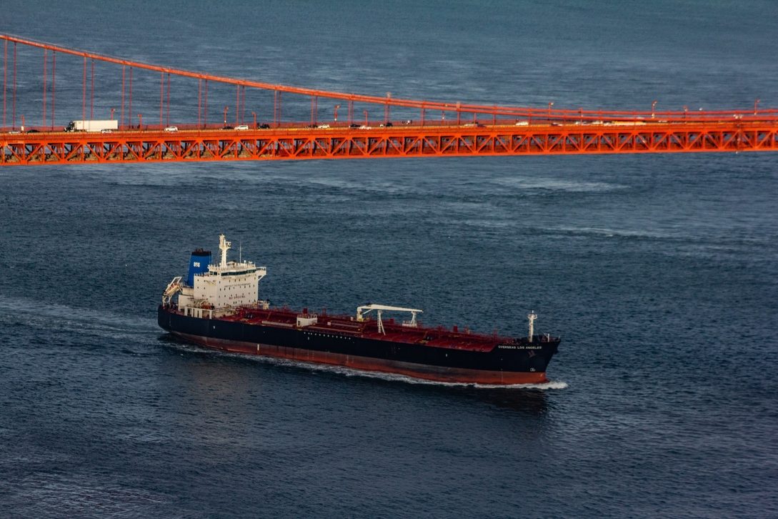 Cargo vessel passing beneath a bridge